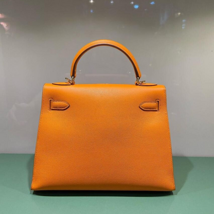 HERMÈS KELLY 25 BAG WITH GOLD HARDWARE IN ORANGE
